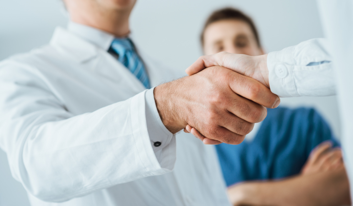 Close up of doctors shaking hands
