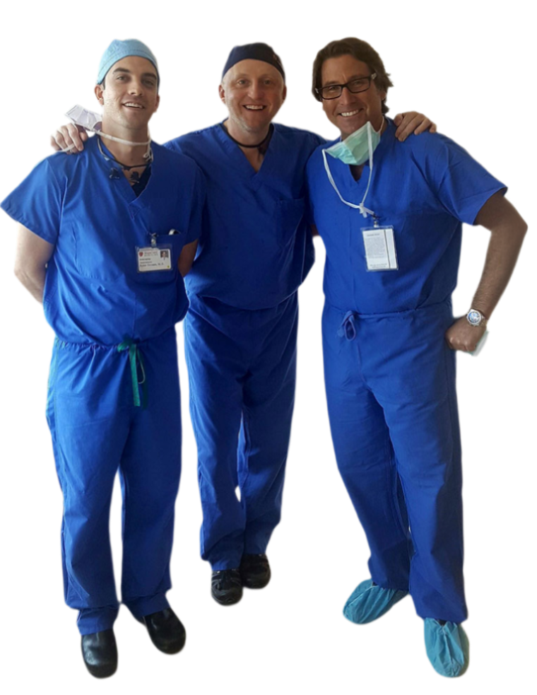 Dr. Mansfield with 2 Other Surgeons wearing scrubs and smiling