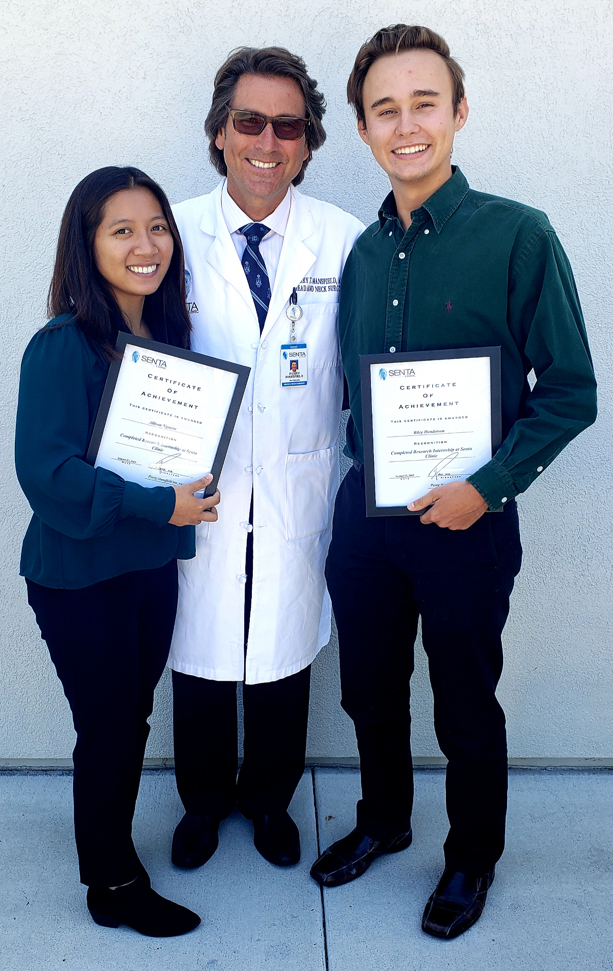 Dr. Perry with Alllison Nguyen and Riley Henderson, with their certificates of achievment.