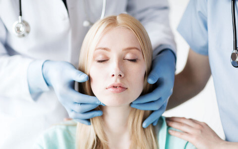 Woman Having Throat Examined