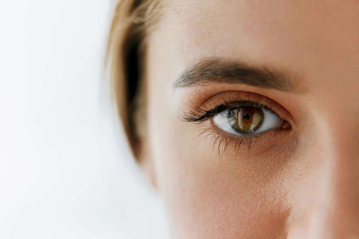 Close up of half of a young woman's face focusing on the eye.