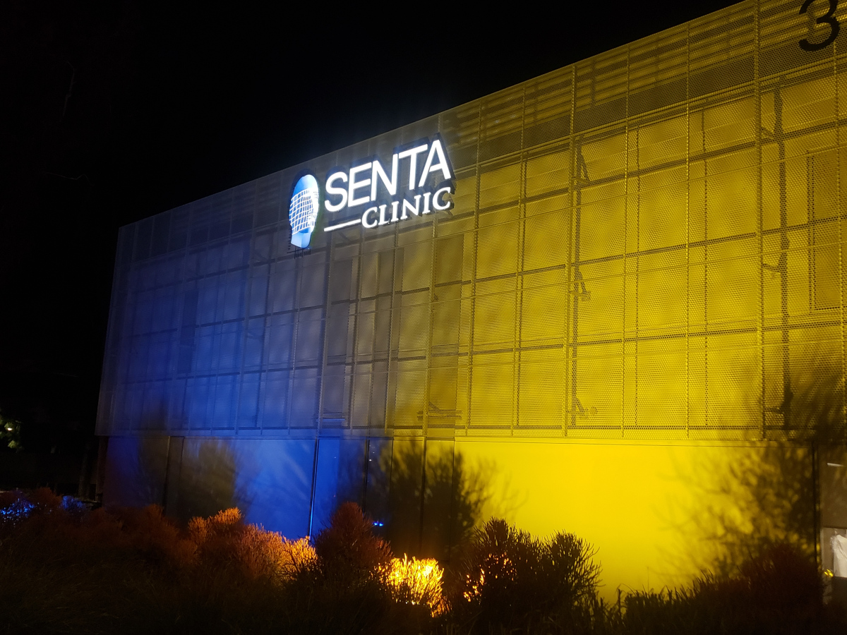 Front of Senta Clinic Building Bathed in Lights of Ukrainian Flag