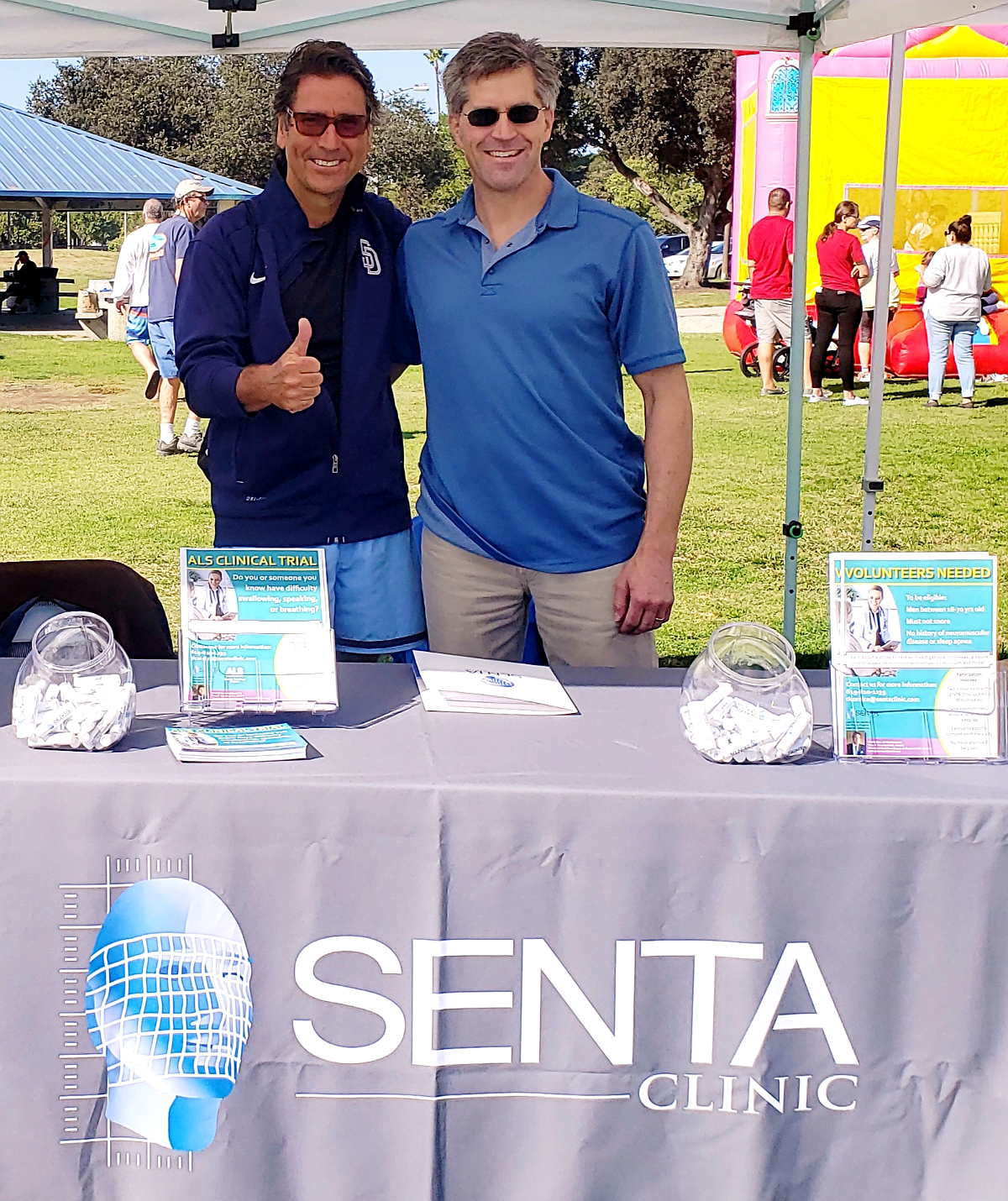 Dr. Mansfield Giving Thumbs Up at ALS Walk for the Cure Event Booth