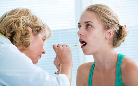 Girl Having Throat Exam by Doctor