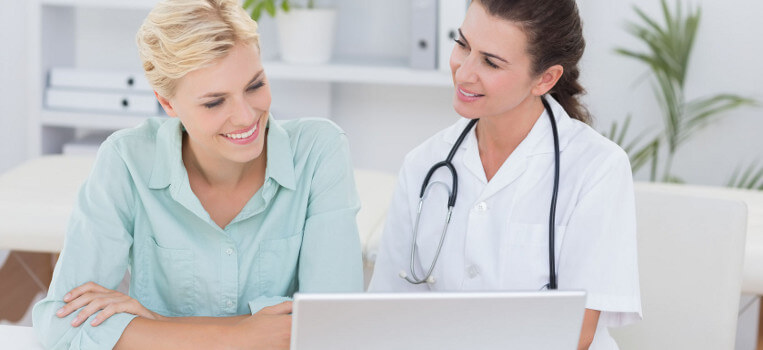 Smiling patient while doctor looks on